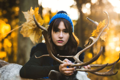 Portrait of young woman looking at camera