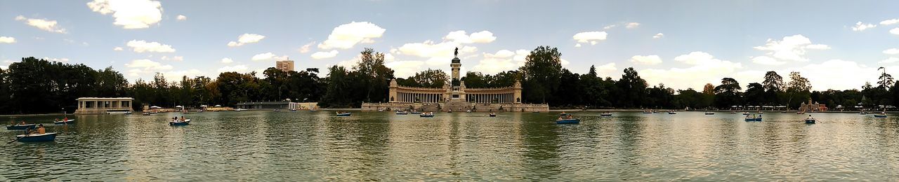 Boats in river with buildings in background