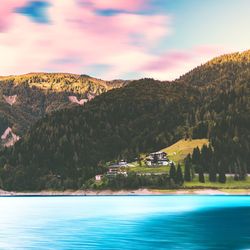 Scenic view of tree mountains by blue lake against sky