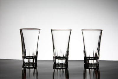 Close-up of glass on table against white background