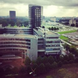 Buildings against cloudy sky