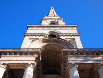 Low angle view of historic building against clear blue sky