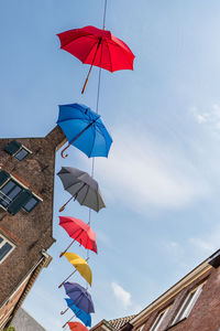 Low angle view of flags against building against sky