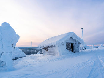 House on snow covered landscape