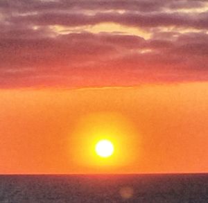 Scenic view of sea against romantic sky at sunset