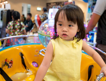 Smiling cute baby girl at amusement arcade