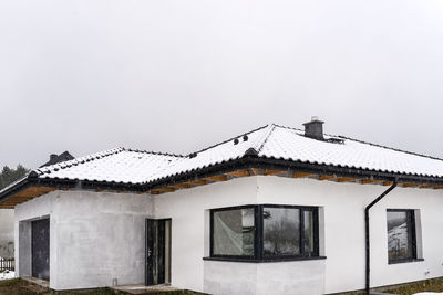 Building against sky during winter