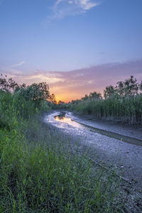 Scenic view of land against sky during sunset