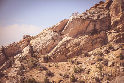 Low angle view of rock formation against sky