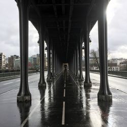 Bridge over river in city against sky