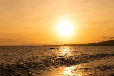 Scenic view of sea against orange sky