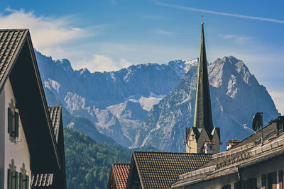 Panoramic view of buildings and mountains against sky