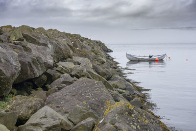 Rocks on sea against sky