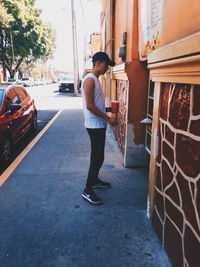 Man standing on street in city