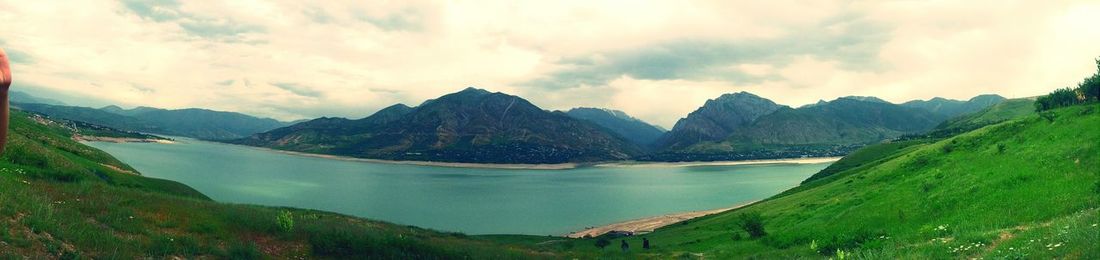 Scenic view of mountains against cloudy sky