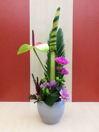 Close-up of potted plant on table against wall