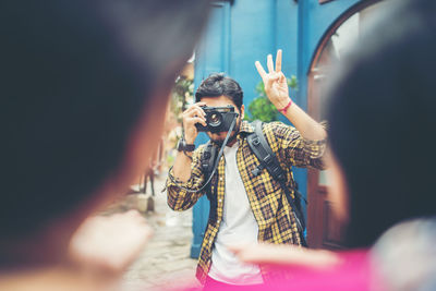 Portrait of man holding camera