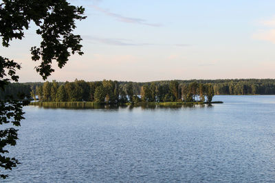 Scenic view of lake against sky at sunset