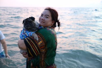 Mother and daughter standing at sea shore