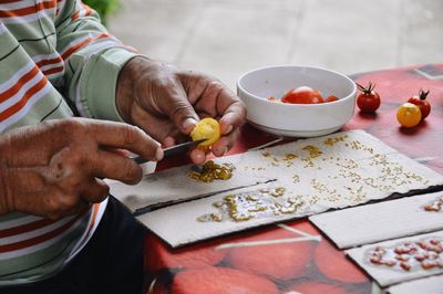 High angle view of man preparing food on table