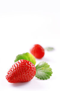 Close-up of strawberry over white background
