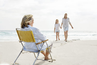 Mother daughter and grandma spending a day on he beach