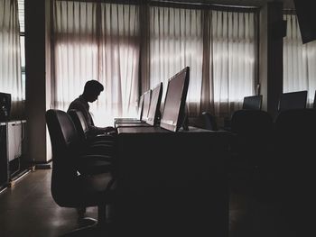 Man working on table in room