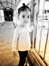 Portrait of cute girl standing in corridor