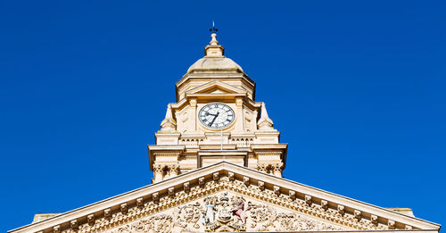 Low angle view of clock tower against sky