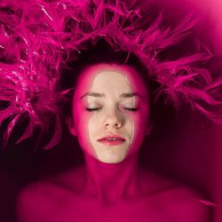 Close-up of young woman with eyes closed relaxing in bathtub