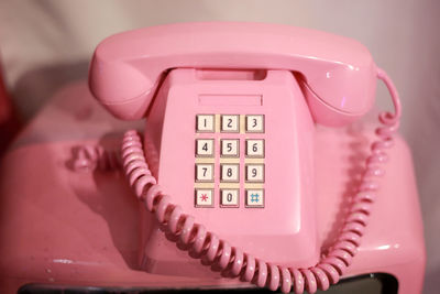 Close-up of telephone booth against wall