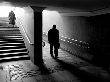 Rear view of people walking on steps