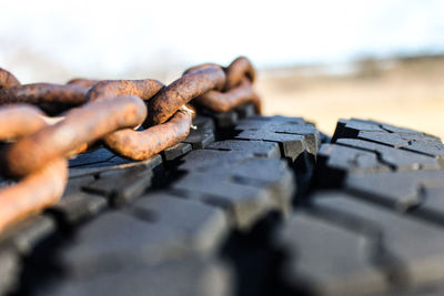 Close-up of rusty metallic chain on rocks