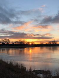 Scenic view of lake against sky during sunset