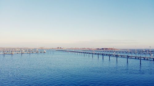 Piers in sea against clear sky