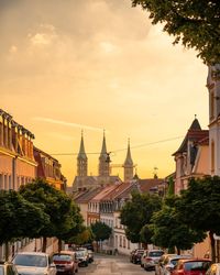 Buildings in city against sky at sunset