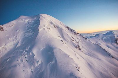 Scenic view of snow mountains against sky