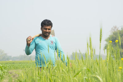 Man standing on field against clear sky