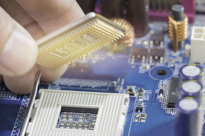 Close-up of mechanic holding computer equipment