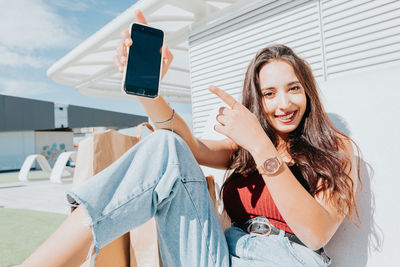 Portrait of young woman using mobile phone