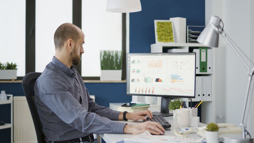 Side view of businessman working at office