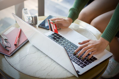High angle view of woman using laptop on table