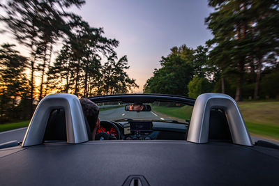 Convertible car, roof down, cruising along coastline road in saulkrasti