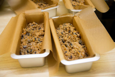 Baking dish with raw dough for christmas cupcake with dried fruit and raisins