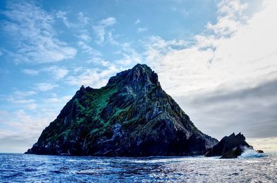 Rock formation on sea against sky