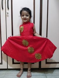 Portrait of girl standing on floor