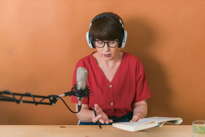 Woman podcasting at studio