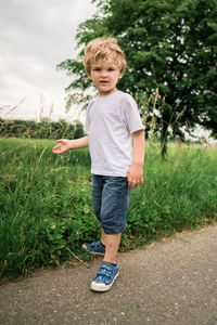 Toddler playing on country road