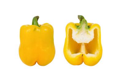 Close-up of yellow bell peppers against white background