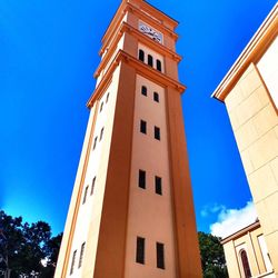 Low angle view of buildings against blue sky